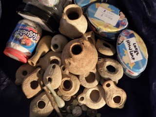 Clay oil lamps, dozens of ancient coins and glass vessels from the Roman period (c. 2,000 years old). The suspect kept the artifacts inside boxes decorated with painted figures
